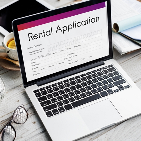tenant approval system header image of laptop with rental application on screen